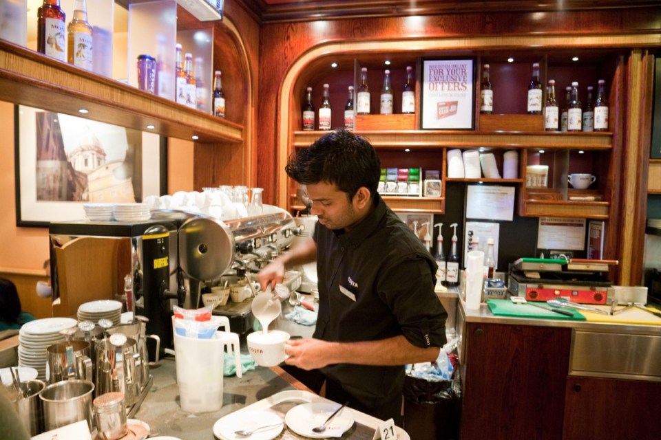 A barista making coffee at Costa Coffee.
