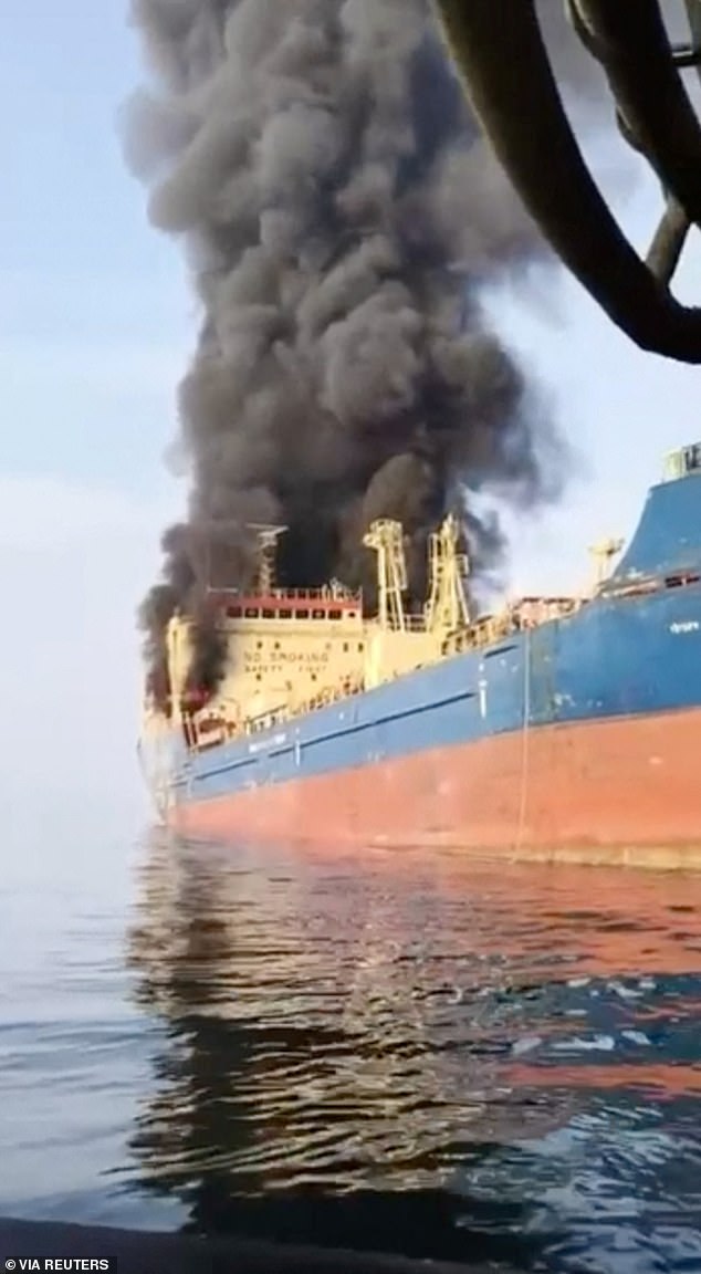 The cruise ship passengers are just the latest holidaymakers to become stranded in the region, with Bother tourists also caught up in the escalating chaos.. Pictured: Smoke billows from an oil tanker under U.S. sanctions, that was hit off Oman's Musandam peninsula
