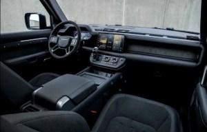 Interior of a modern vehicle with a black dashboard, steering wheel, and seats.