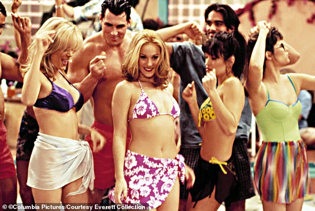 Here she was seen in a purple-and-white bikini top with matching sarong for a party scene