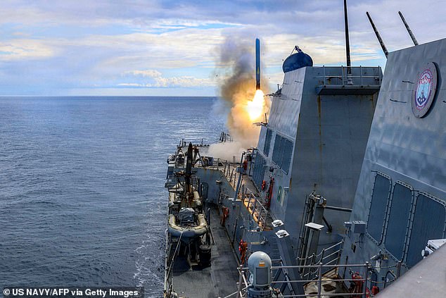 This US Navy handout photo released by US Central Command public affairs shows the Arleigh Burke-class guided-missile destroyer USS Thomas Hudner (DDG 116) firing a Tomahawk land attack missile in support of Operation Epic Fury on March 1
