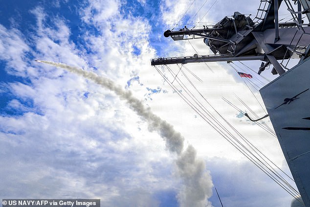 This US Navy handout photo released by US Central Command public affairs shows the Arleigh Burke-class guided-missile destroyer USS Thomas Hudner (DDG 116) firing a Tomahawk land attack missile in support of Operation Epic Fury on March 1