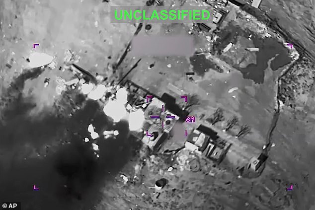 This partially redacted image from video provided by U.S. Central Command shows a complex of structures in Iran being struck by missiles fired by U.S. forces on Sunday