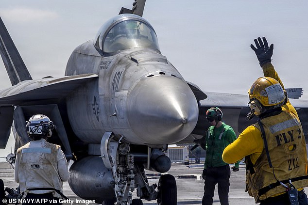 This US Navy handout photo released by US Central Command public affairs shows an F/A-18E Super Hornet, attached to Strike Fighter Squadron (VFA) 151, preparing to launch from the flight deck of Nimitz-class aircraft carrier USS Abraham Lincoln (CVN 72) in support of Operation Epic Fury on March 2