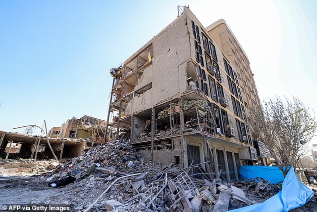 The exposed interior of a heavily-damaged building is pictured near Ferdowsi square in Tehran on March 3