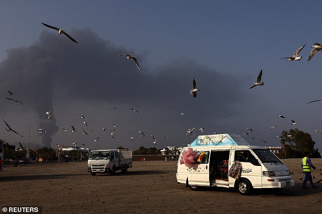 Birds fly as smoke rises in the Fujairah oil industry zone following a fire caused by debris after interception of a drone by air defenses, according to the Fujairah media office, amid the U.S.-Israel conflict with Iran, in Fujairah, United Arab Emirates, March 3