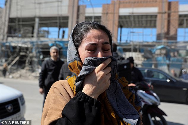 A woman reacts on the street following an Israeli and U.S. strike on a police station, amid the U.S.-Israeli conflict with Iran, in Tehran, Iran, March 3