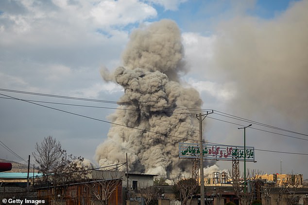 A plume of smoke rises after an explosion in Tehran
