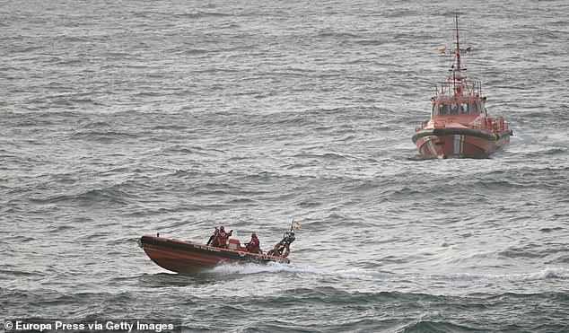 Police, firefighters, the coastguard and local government, which has provided a helicopter, are all helping with search and rescue efforts to find the missing. Pictured: Rescue teams at the scene