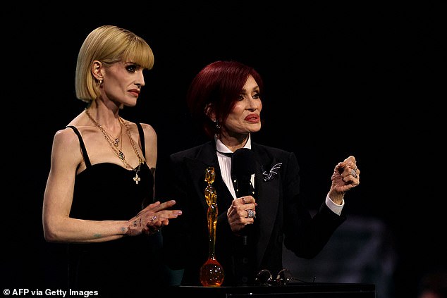 Kelly with her mother Sharon on stage at the BRITs on Saturday, where she accepted a posthumous Lifetime Achievement on behalf of her beloved dad