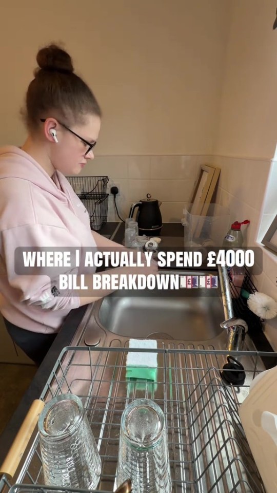 A young woman doing dishes in a kitchen sink, with text overlay "WHERE I ACTUALLY SPEND £4000 BILL BREAKDOWN".