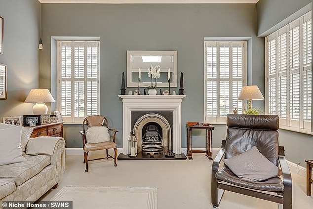 The lounge area of the property is fit with a sleek fireplace and spacious sofa