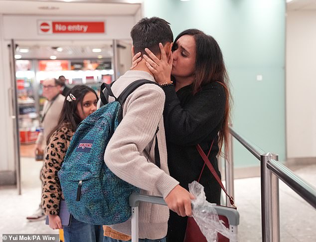 Family members reunite after flights arrive into Heathrow from Dubai on March 3