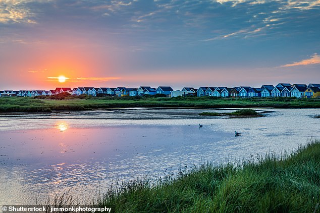 Mudeford Sandspit Lagoon with its beach huts on Mudeford Sandbank