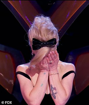 Osbourne briefly placed her face into her hands as the crowd erupted into applause to offer support