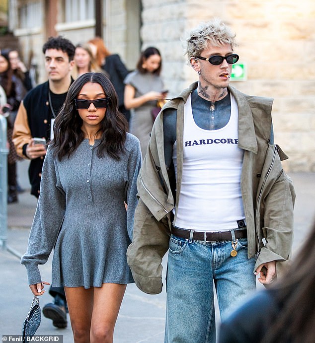 The duo coordinated in dark sunglasses as the music artist smoked a cigarette