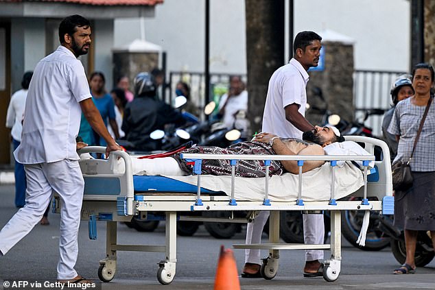 Rescuers plucked 32 survivors from the Indian Ocean while 87 bodies were recovered from the water. Pictured: An injured Iranian soldier is taken into a hospital in Galle, Sri Lanka, after the strike