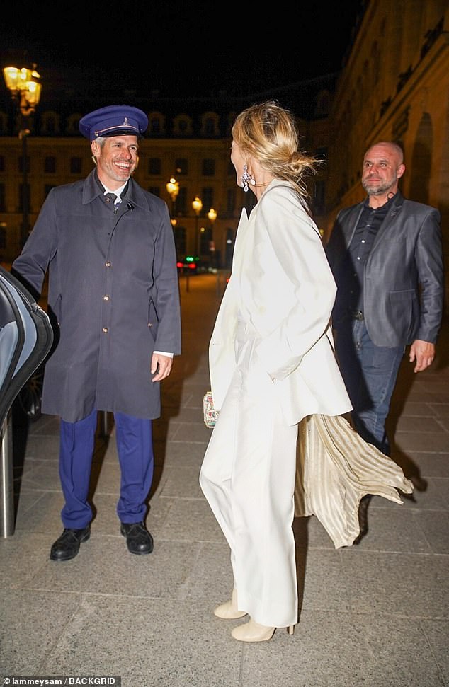 Kate added inches to her frame with a pair of nude heels and toted her essentials in a clutch bag, further accessorising the look with a draped scarf