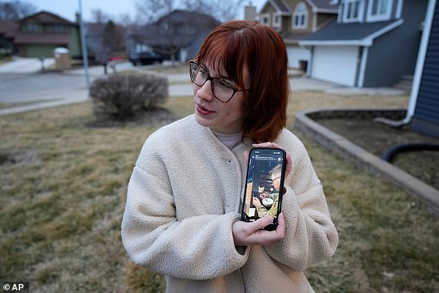 His sister Keara (pictured holding a photo of her brother) shows a photo of her brother taken the morning before they dropped him off to leave