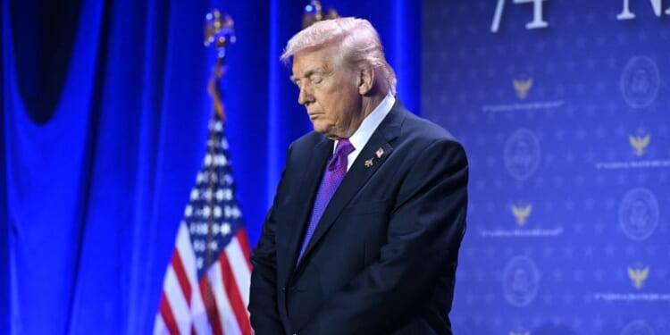 President Donald Trump bows his head in prayer during the National Prayer Breakfast at the Washington Hilton in Washington, D.C., on Feb. 5, 2026.