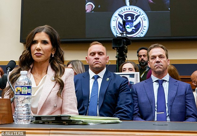 Noem's husband, Bryon, could be seen sitting behind his wife with a deadpan expression as she faced continued grilling over her relationship with Corey Lewandowski
