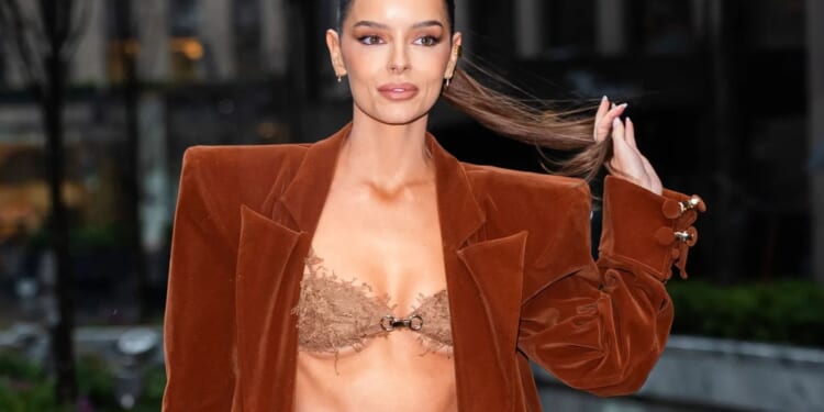 Maura Higgins turns heads with her abs as she steps out in her BRA with oversized coat
