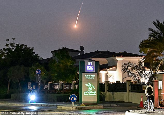 A cyclist watches in horror as a supersonic missile launched by Iran falls over Dubai