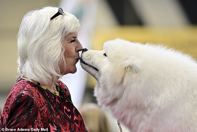 One woman was snapped giving her dog a kiss on the lips ahead of an event