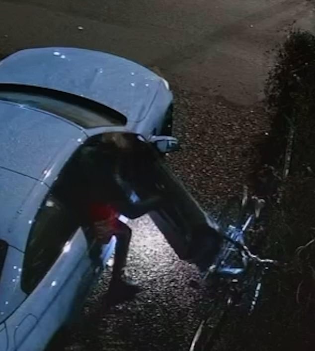 He is seen letting himself in through the driver's side door before rummaging through the car's interior