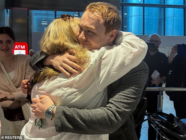 Ms Short hugs her son Alex as she arrives at Heathrow International Airport from Oman