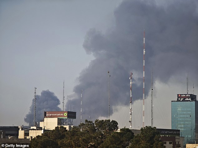 Smoke rises over buildings following explosions in the central region of Tehran on Friday morning