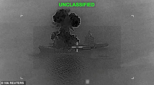 Smoke rises from what U.S. Central Command (CENTCOM) says is an Iranian drone carrier that was struck by US forces