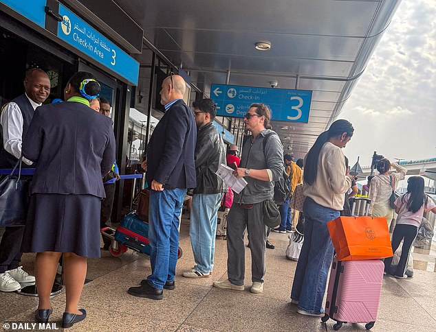 Passengers show their passport and a valid ticket to be allowed into Dubai Airport today