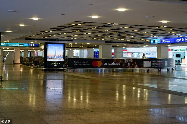 A worker is seen in the empty arrivals hall at Dubai Airport yesterday
