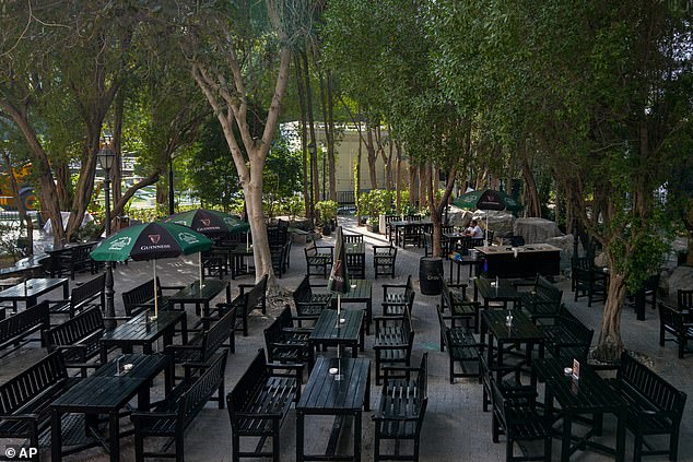 A patron sits at an otherwise-empty outdoor restaurant in Dubai yesterday