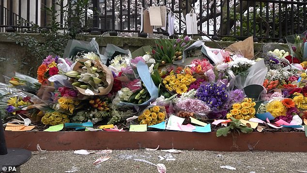 People lay flowers at the scene of the crash in memory of the physics and philosophy student
