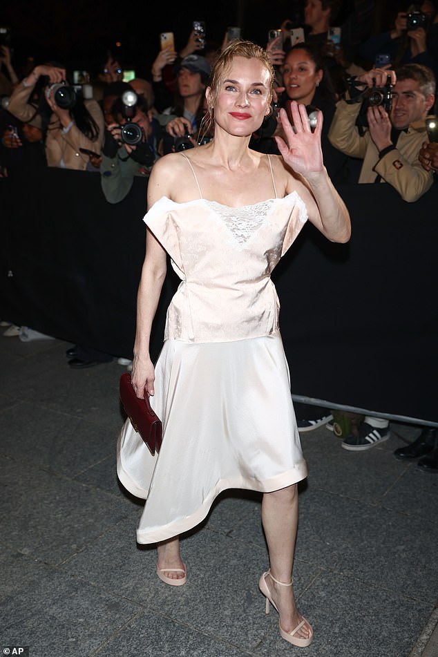 German actress Diane Kruger was seen arriving for the show in Paris as she donned a cream asymmetric dress featuring a lace cut-out bodice