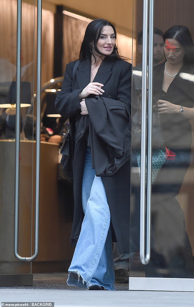 Annie smiled for the cameras as her sister Sian followed close behind