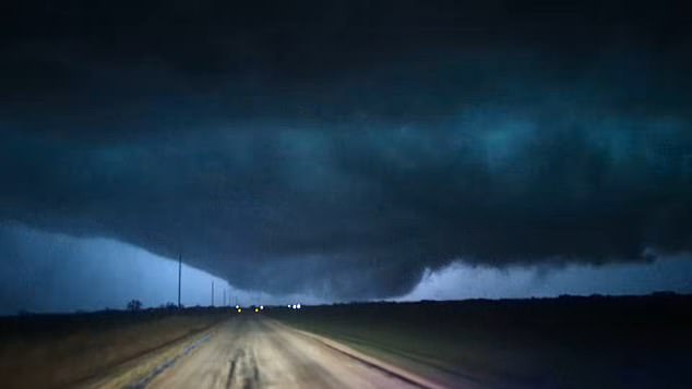Video captured by a first responder near Fairview showed lightning illuminating a large funnel cloud appearing to extend toward the ground