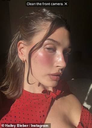 Her dark, bob-length hair was parted down the middle and worn half-up, half-down