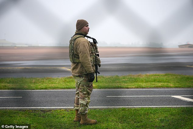 An armed airman of the US Air force guards the perimeter fence at RAF Fairford after a B1 Lancer bomber landed last night