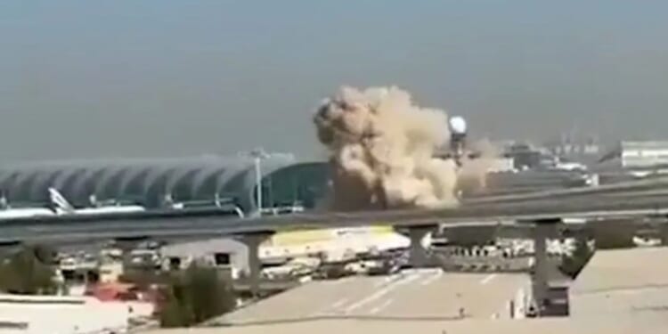 Shocking moment Dubai airport hit in Iran suicide drone blitz as all flights suspended 'until further notice'