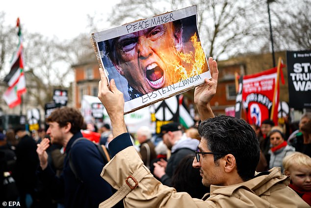 One demonstrator was seen holding a picture of the US President on fire, as well as making an apparent reference to an antisemitic conspiracy