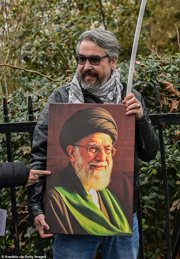 Another held aloft an image of the now dead Iranian Supreme Leader Ali Khamenei - a regime leader who killed thousands of his own Iranians earlier this year