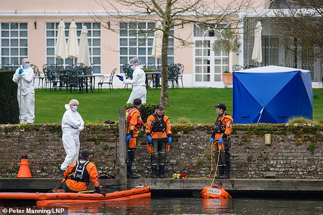 Officers rushed to Phyllis Court Drive shortly before 8am on Friday, where they found the woman's body. Pictured: A police search team and forensic investigators search for evidence in the River Thames