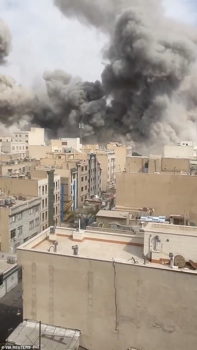 Smoke was seen rising in the Iranian capital of Tehran on Saturday after Trump promised to hit the country 'very hard' today