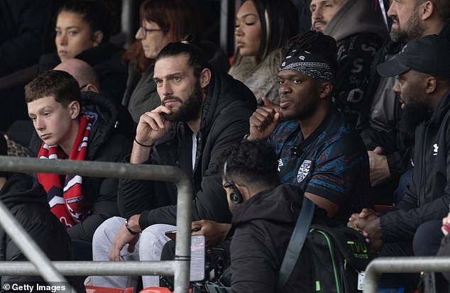 Andy appeared in high-spirits next to influencer KSI as they cheered on Dagenham and Redbridge in the National League South fixture at Chigwell Construction Stadium