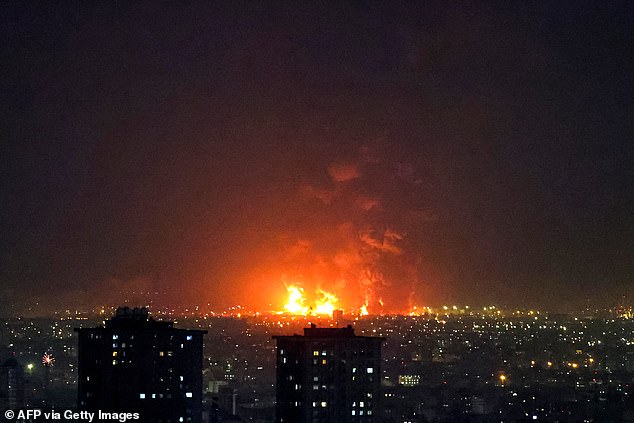 A UK security source said: 'We are inside the country now looking for them, across four sites narrowed down by Tel Aviv'. Pictured: Explosions after a strike on Tehran on Saturday