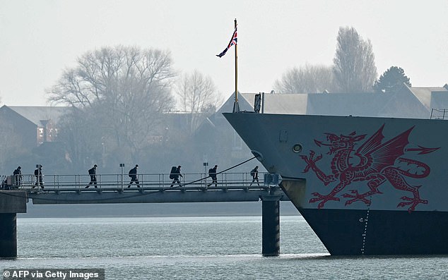 It prompted Sir Keir to announce that HMS Dragon, which is equipped with state-of-the-art missile defence systems, would be deployed to the region to defend the base. Pictured: Troops board the warship, moored in Portsmouth, on Wednesday
