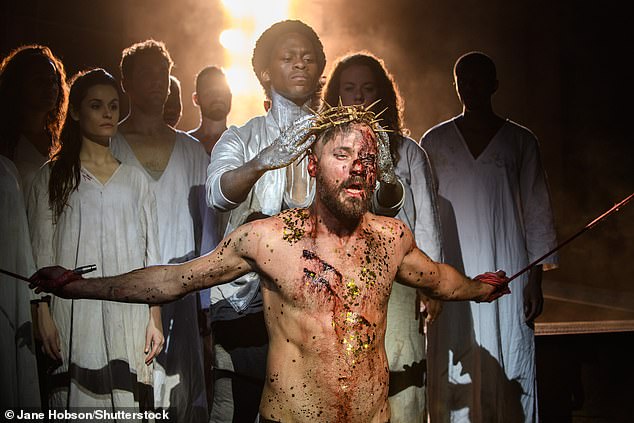 A shot from a performance of the crucifixion scene from Jesus Christ Superstar in Regent's Park Open Air Theatre, London in 2016